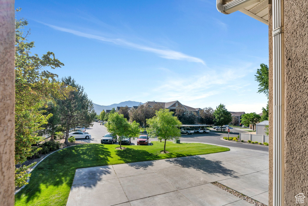 View of green lawn featuring a mountain view