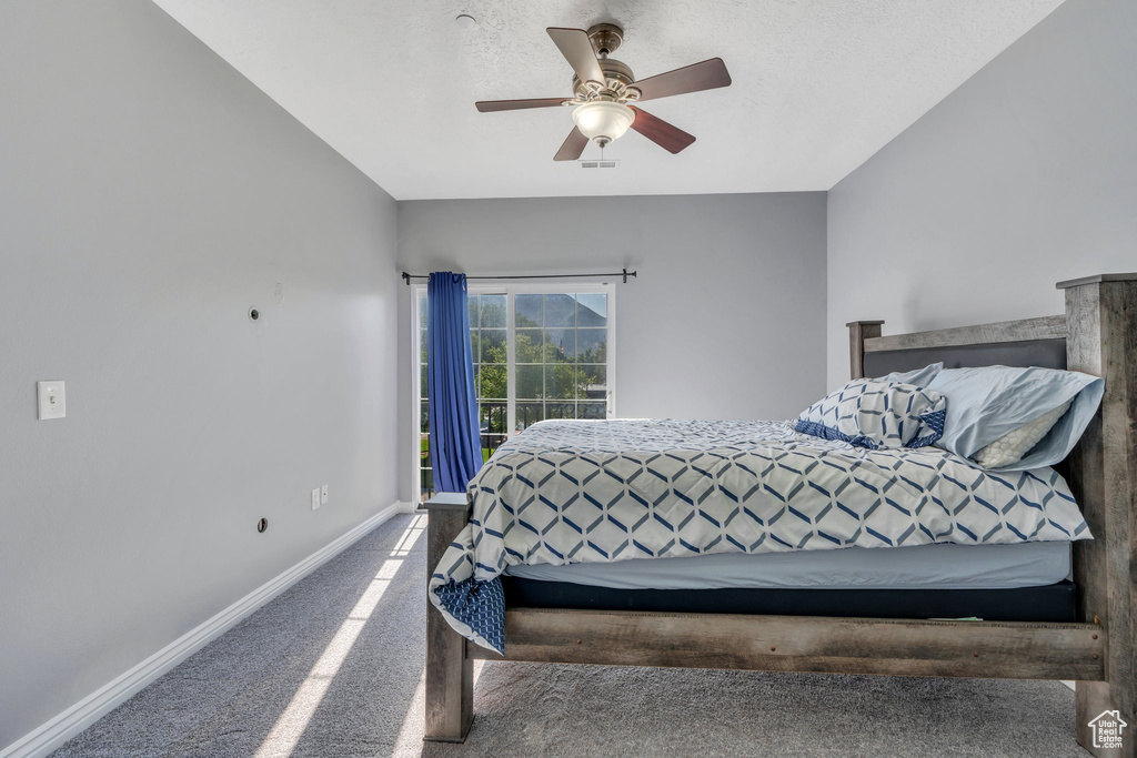 Bedroom with carpet floors, baseboards, and ceiling fan
