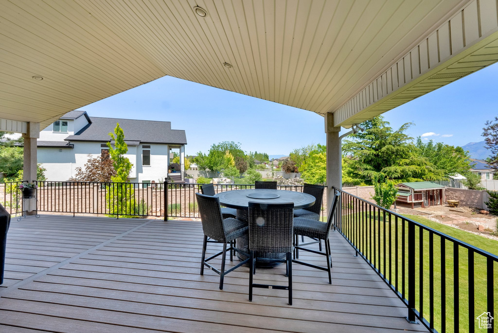 Wooden terrace featuring outdoor dining area