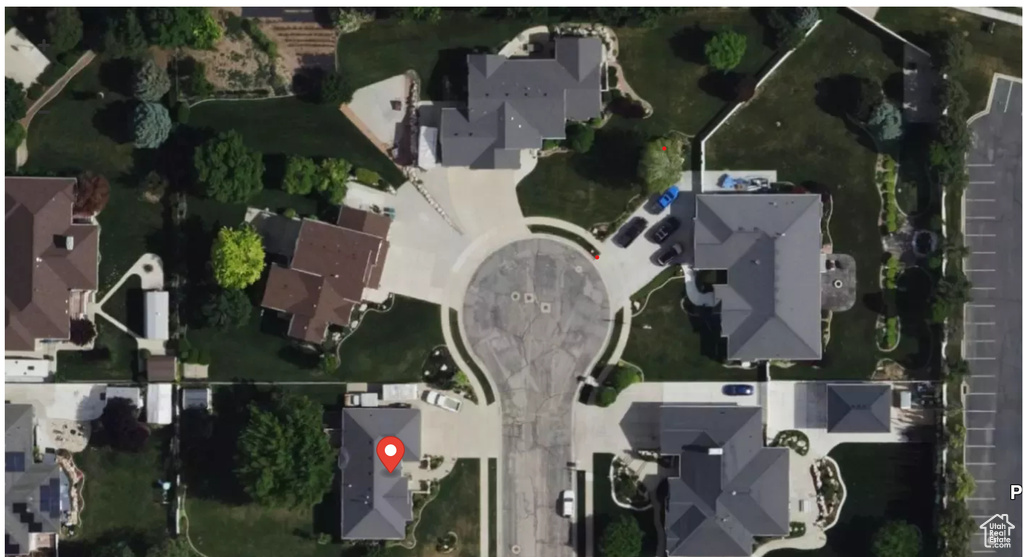 Aerial view of property and surrounding area featuring nearby suburban area