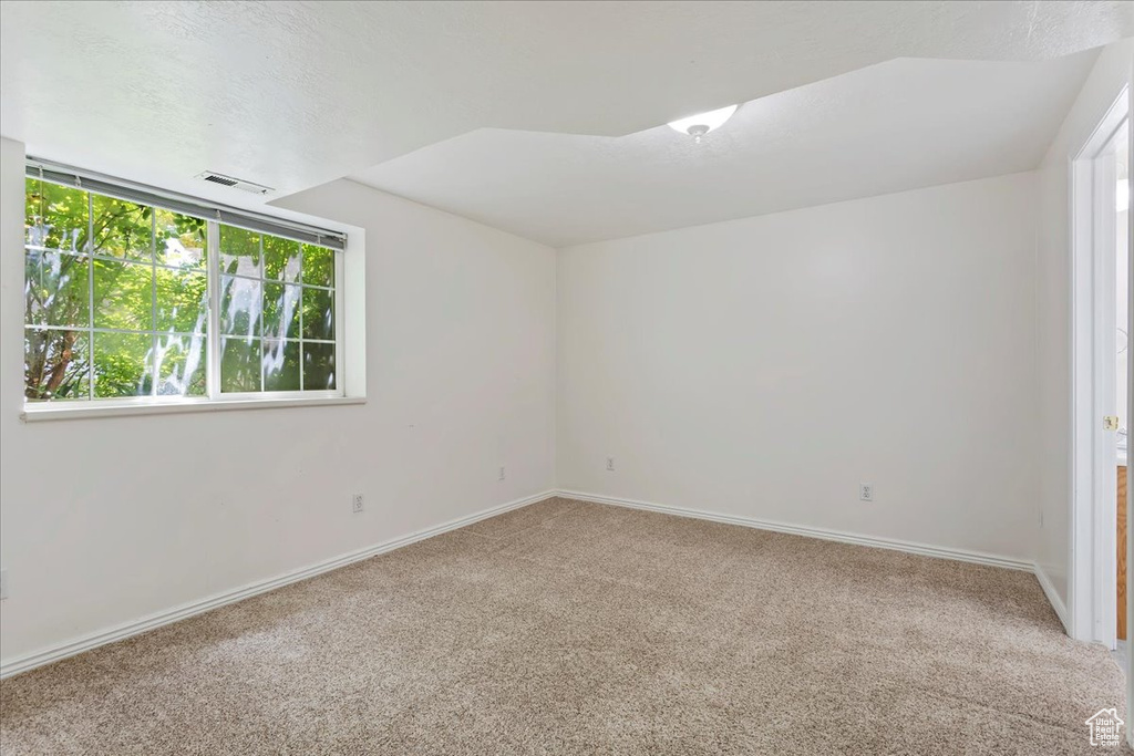 Carpeted empty room featuring baseboards