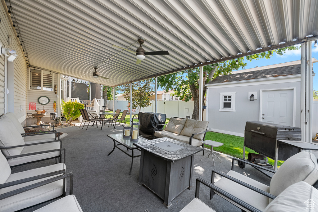 View of patio featuring outdoor dining space, an outdoor living space, ceiling fan, and area for grilling