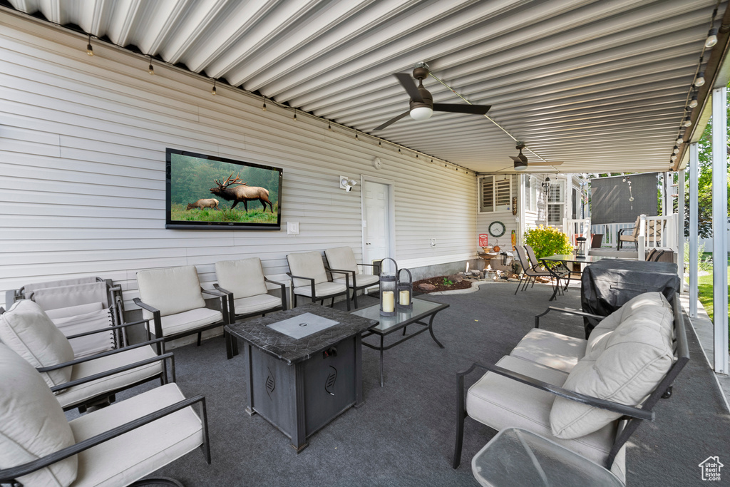 View of patio with an outdoor hangout area and ceiling fan