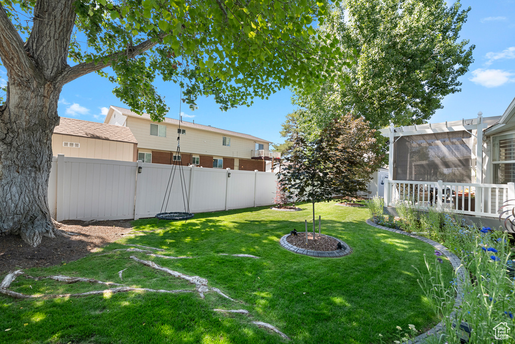 View of yard featuring a sunroom