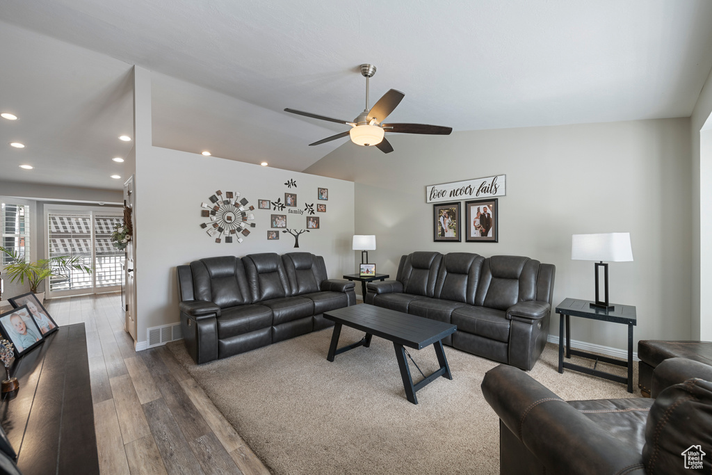 Living room featuring recessed lighting, wood finished floors, ceiling fan, baseboards, and vaulted ceiling