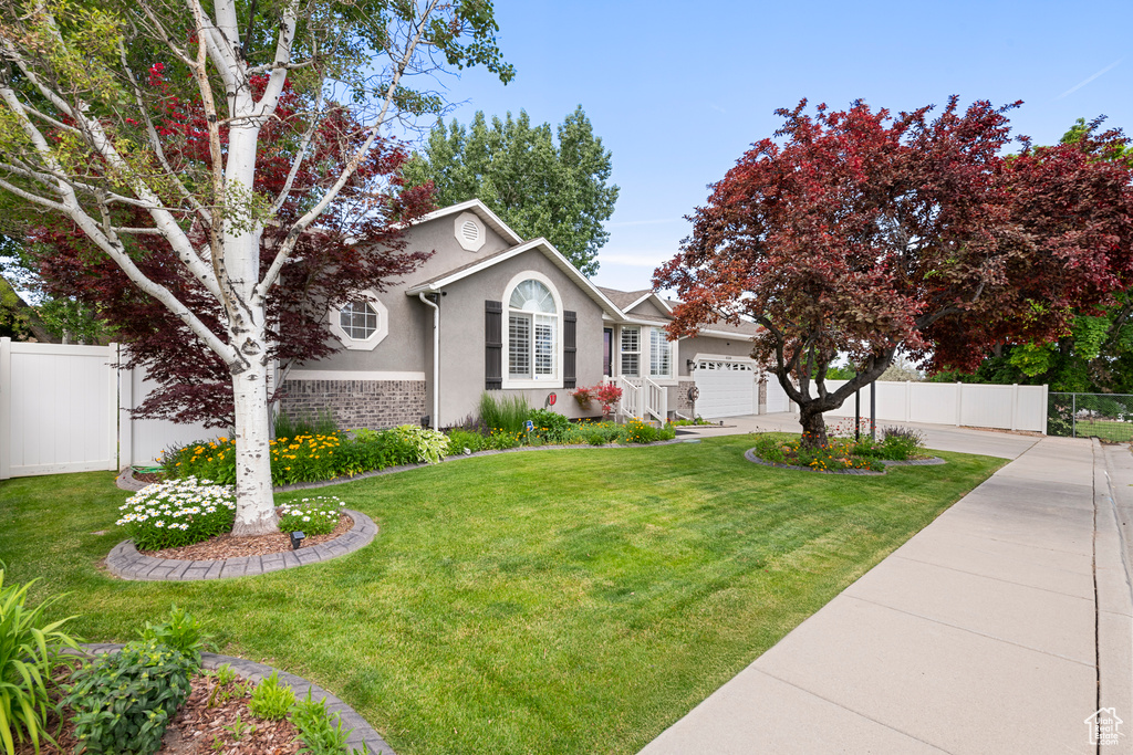 View of front of home featuring a garage, stucco siding, and driveway