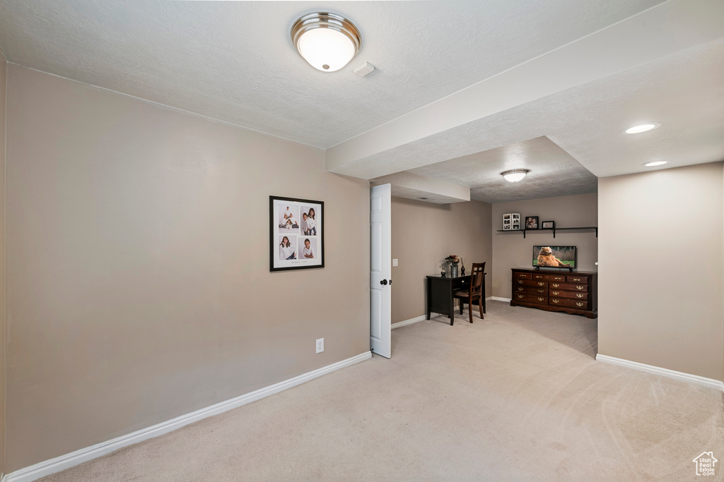 Finished basement with carpet, baseboards, recessed lighting, and a textured ceiling