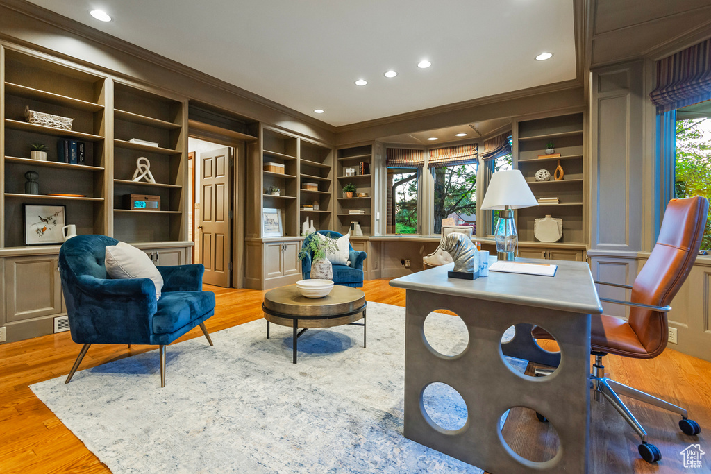 Office area with ornamental molding, wood finished floors, built in features, and recessed lighting