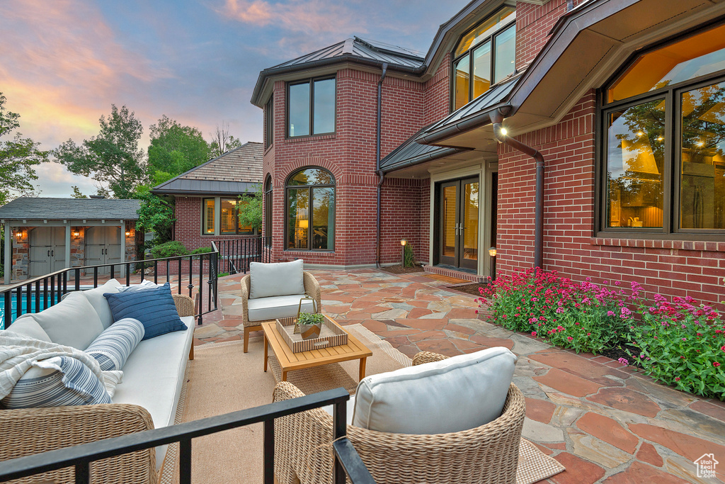 View of patio with an outdoor living space, french doors, and an outdoor structure