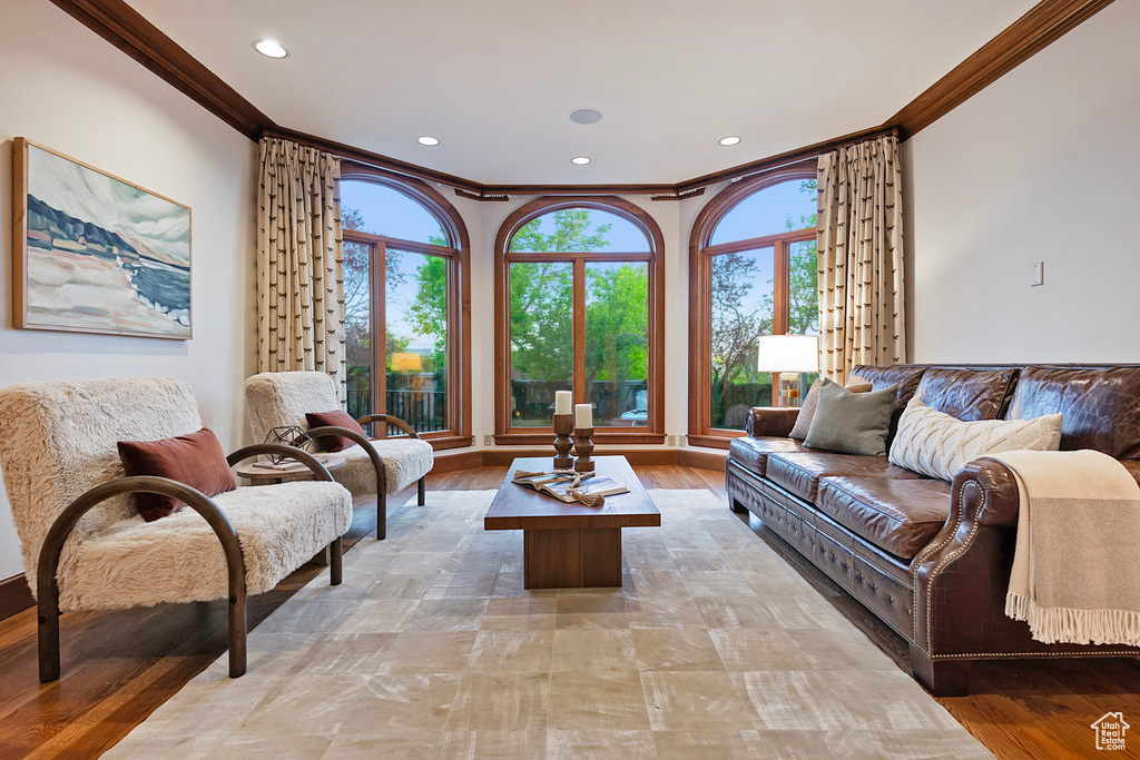 Living area featuring ornamental molding, recessed lighting, and light wood-style floors