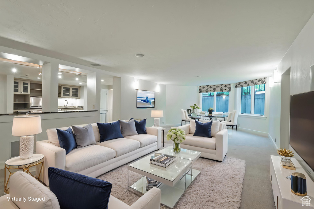 Living room featuring recessed lighting, baseboards, and carpet floors