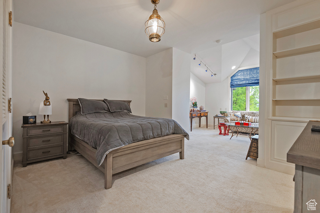 Bedroom featuring vaulted ceiling and light carpet