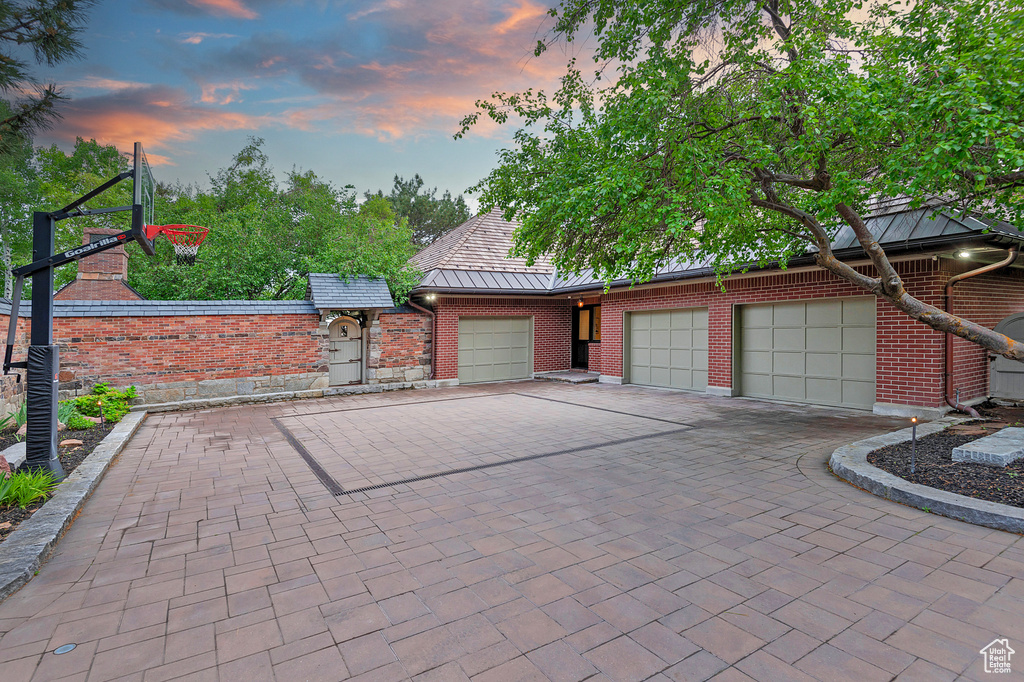 Garage at dusk featuring driveway