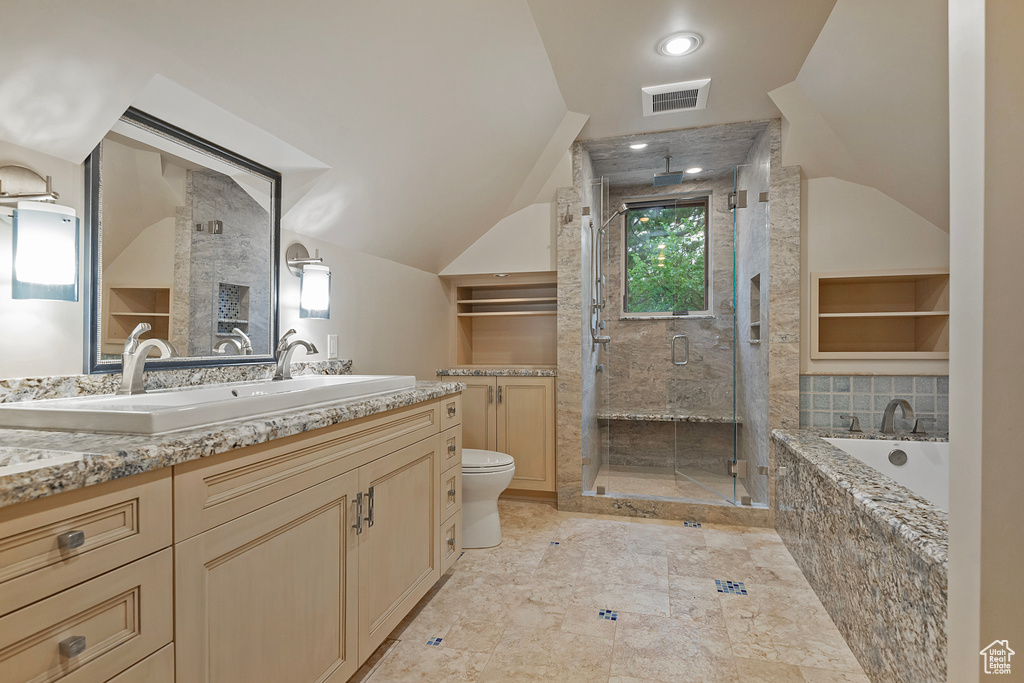 Full bath with lofted ceiling, a shower stall, vanity, toilet, and a garden tub