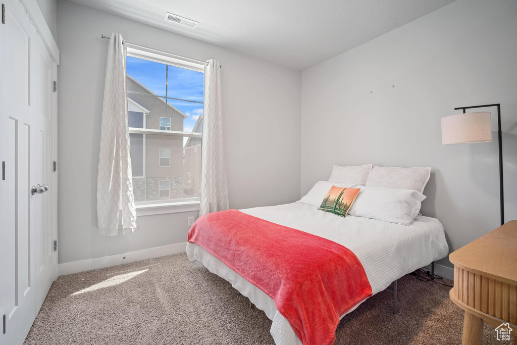 Bedroom featuring carpet floors and baseboards
