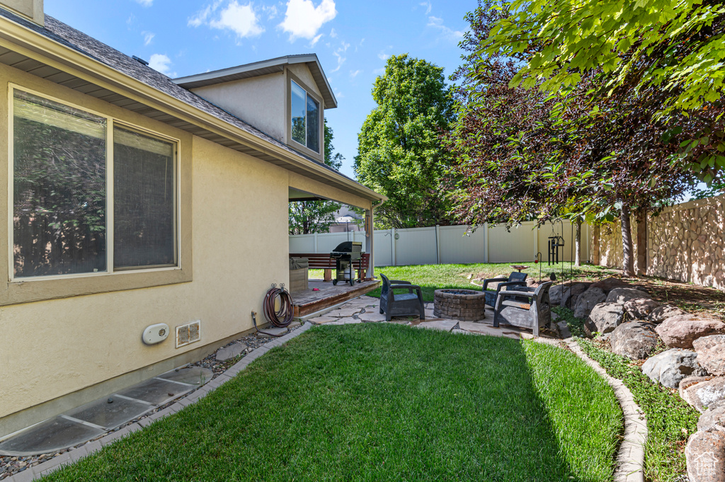 View of yard with a patio and an outdoor fire pit