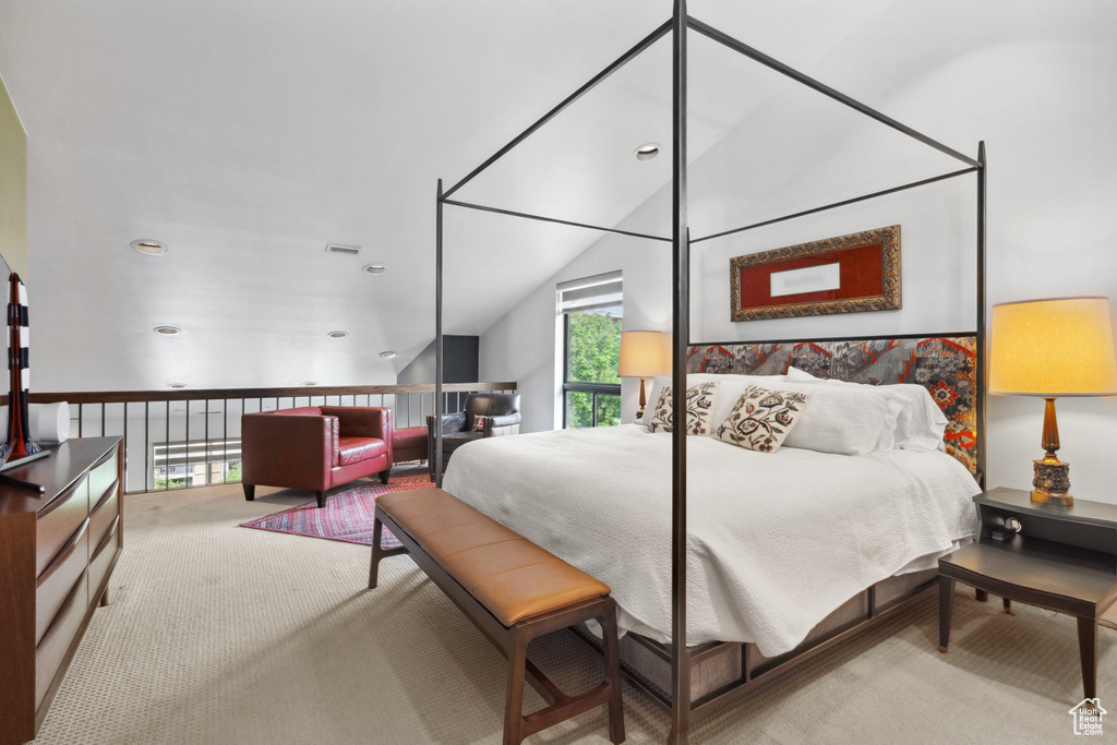 Bedroom with carpet floors and vaulted ceiling