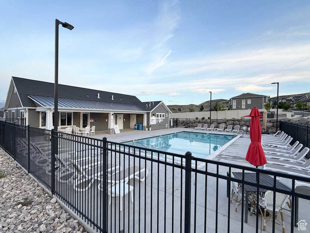 Community pool featuring a patio and a residential view