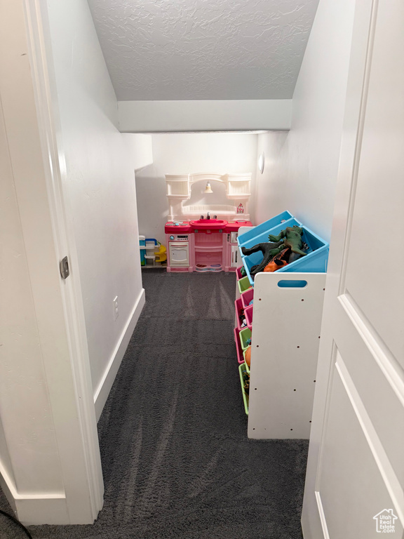 Game room featuring carpet flooring and a textured ceiling