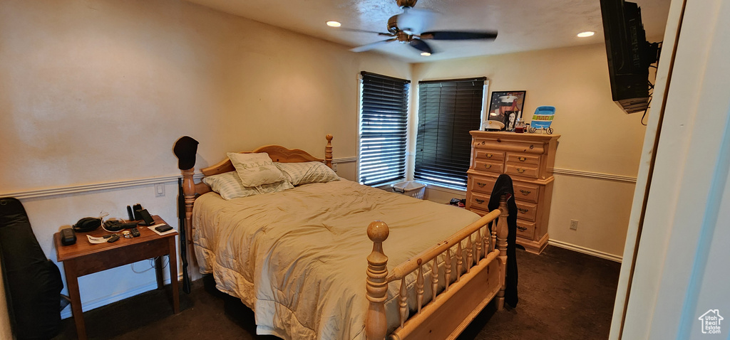 Bedroom with recessed lighting, ceiling fan, baseboards, and dark colored carpet