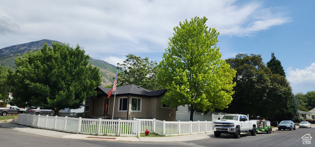 View of asphalt road featuring sidewalks and a mountain view