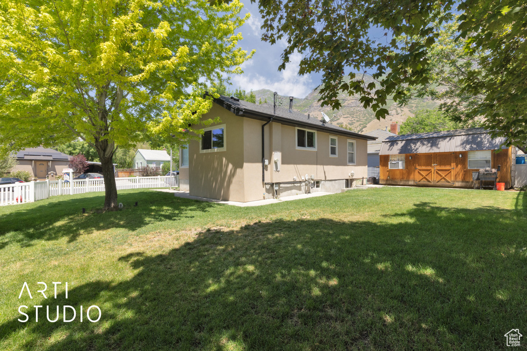 Rear view of property with stucco siding