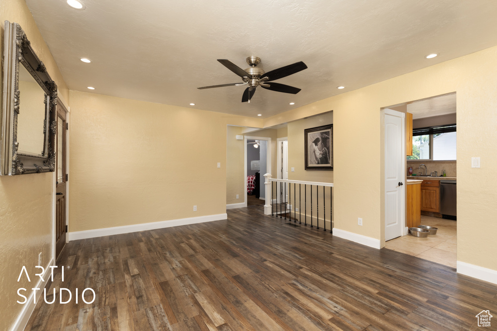 Spare room with a ceiling fan, wood finished floors, recessed lighting, and baseboards