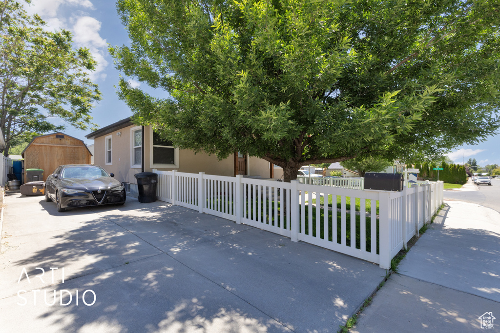 Obstructed view of property featuring a fenced front yard
