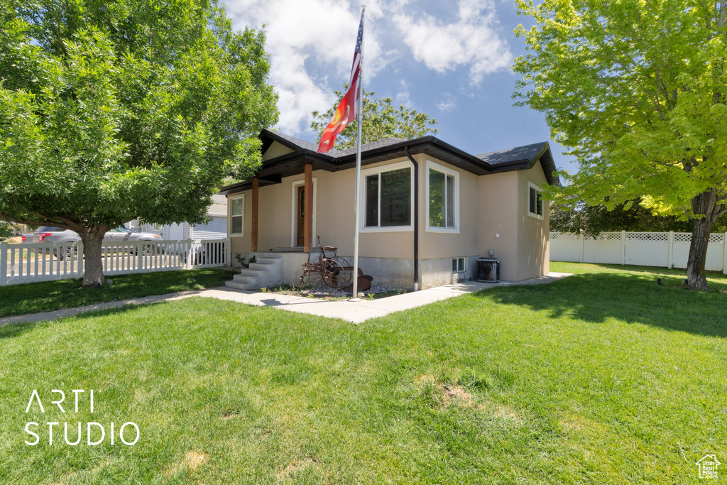 View of front of home featuring stucco siding and central air condition unit
