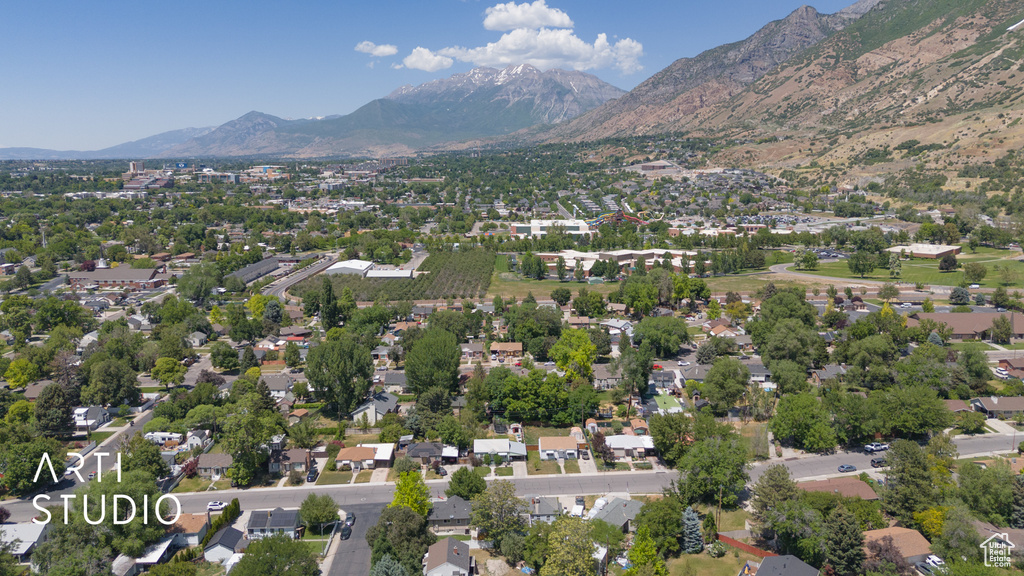 Aerial overview of property's location featuring a mountain backdrop and nearby suburban area