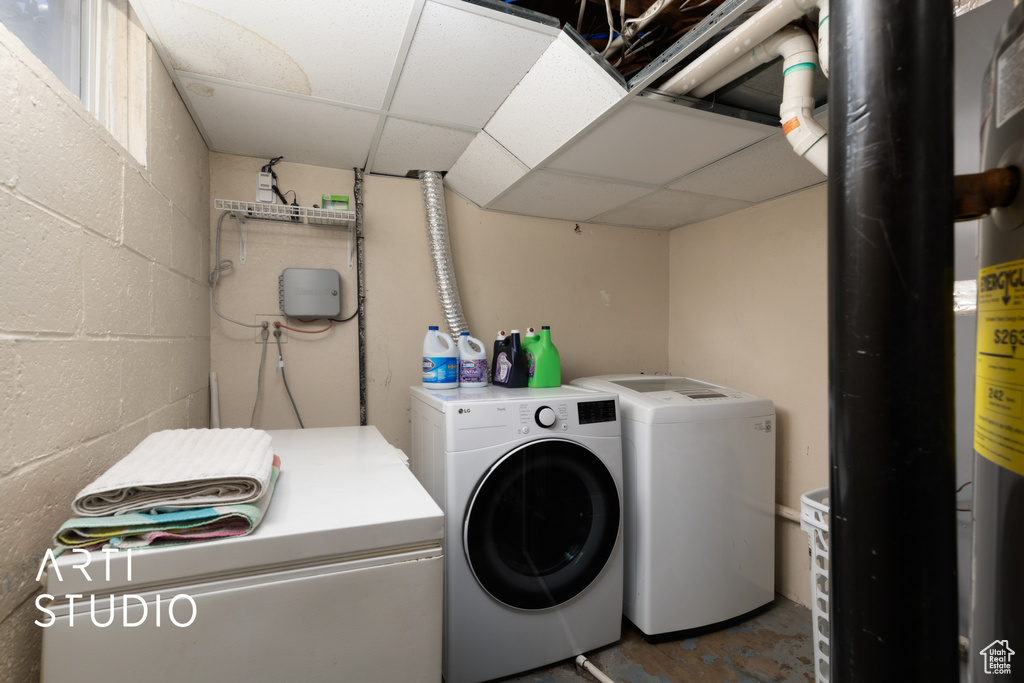 Laundry room with washer and dryer and concrete block wall