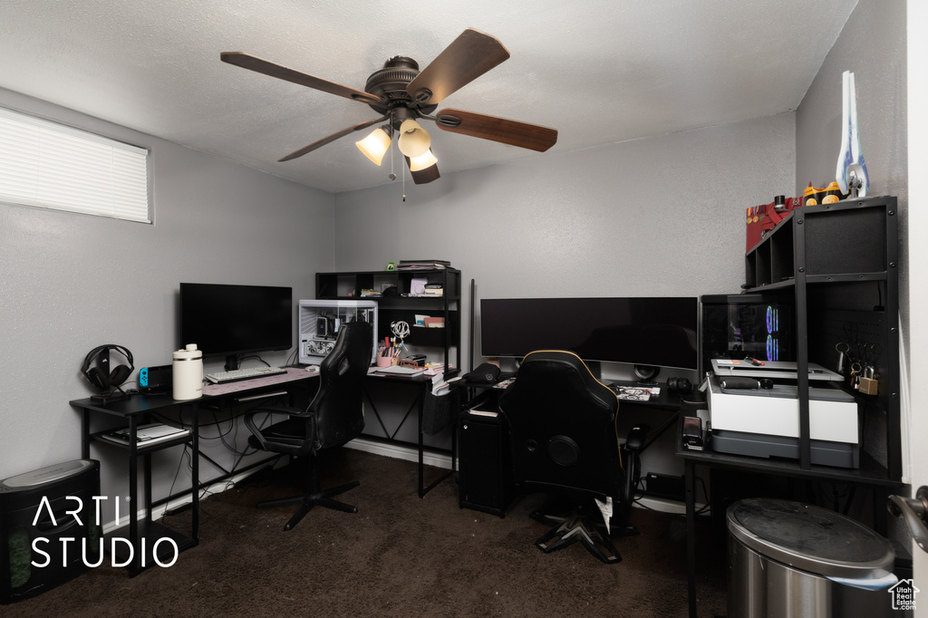 Carpeted home office with ceiling fan