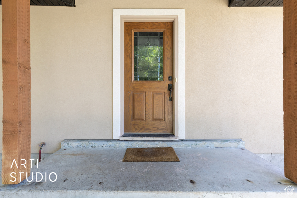 Entrance to property with stucco siding