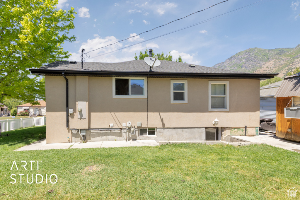 Back of house featuring stucco siding and a mountain view