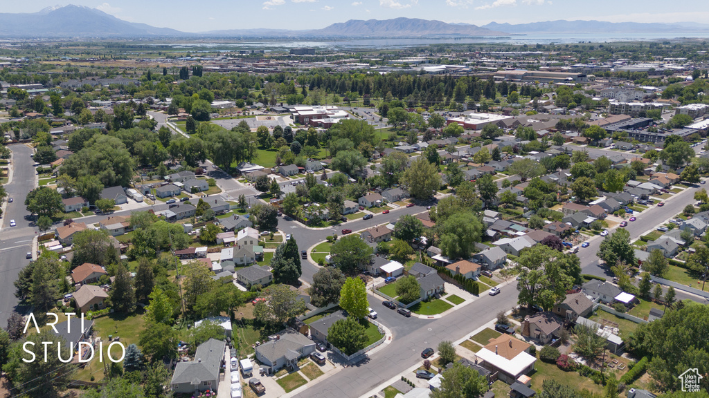 Aerial overview of property's location featuring mountains and nearby suburban area