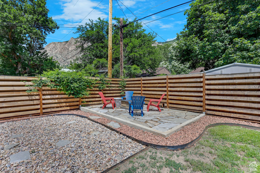 Fenced backyard with a patio area and an outdoor fire pit