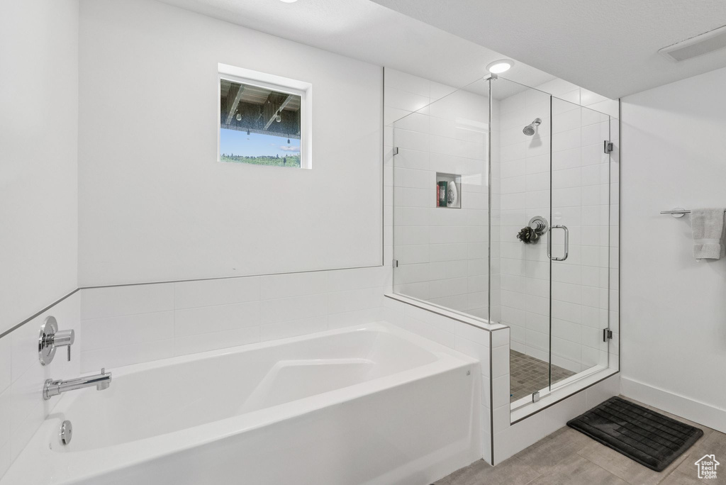 Bathroom featuring a garden tub and a stall shower