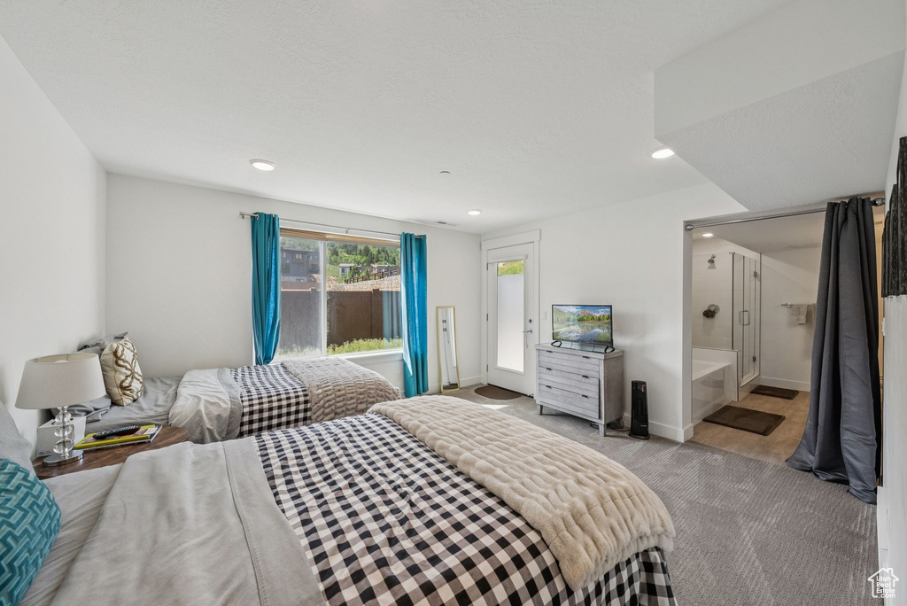 Bedroom featuring light colored carpet, recessed lighting, ensuite bath, baseboards, and access to outside