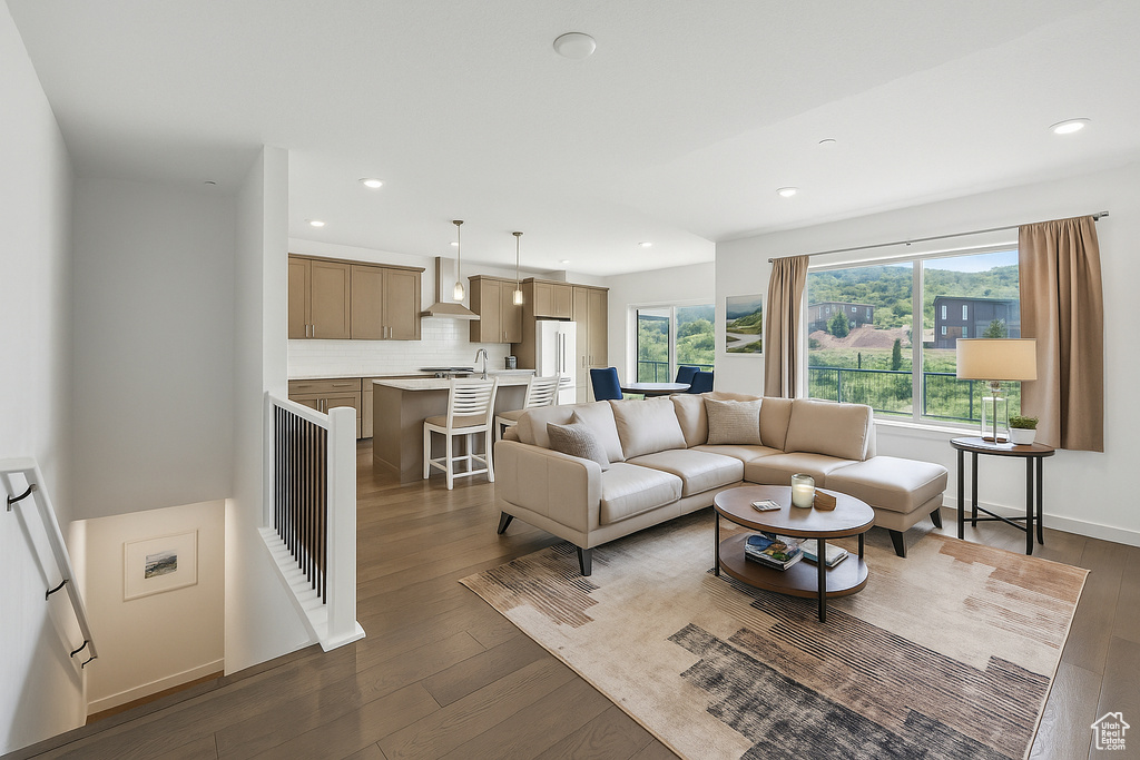 Living room featuring dark wood-style floors and recessed lighting