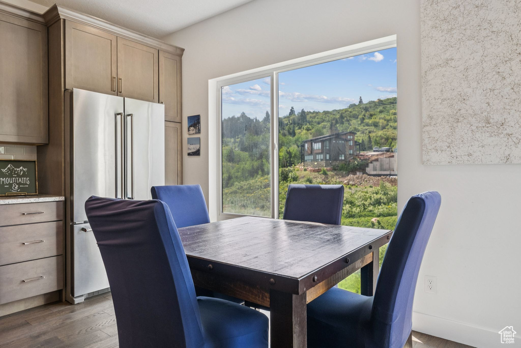 Dining area with plenty of natural light and wood finished floors