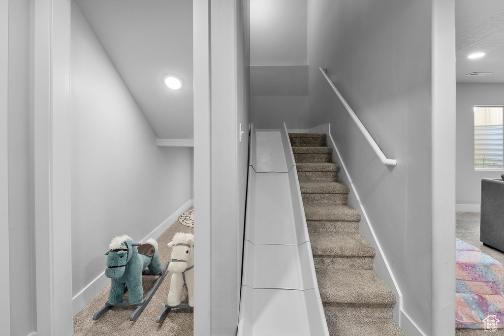 Stairs featuring carpet, recessed lighting, and baseboards