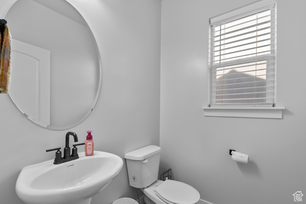 Half bathroom with a sink and toilet