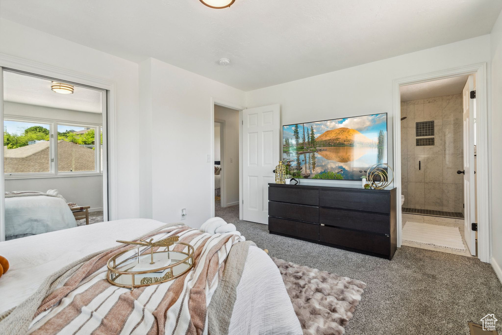 Carpeted bedroom featuring connected bathroom