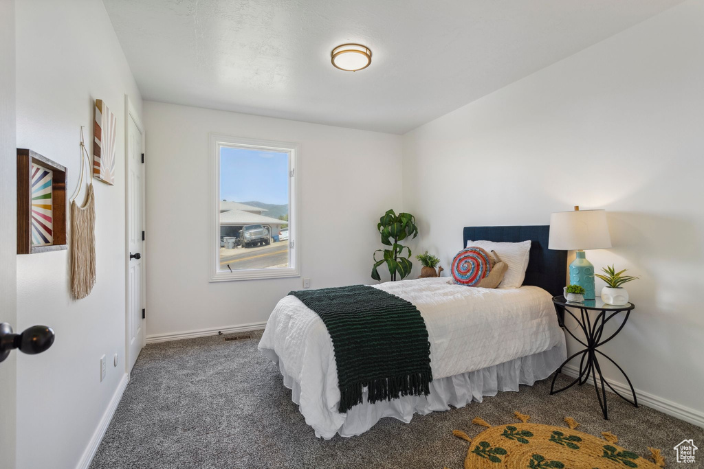 Carpeted bedroom with baseboards