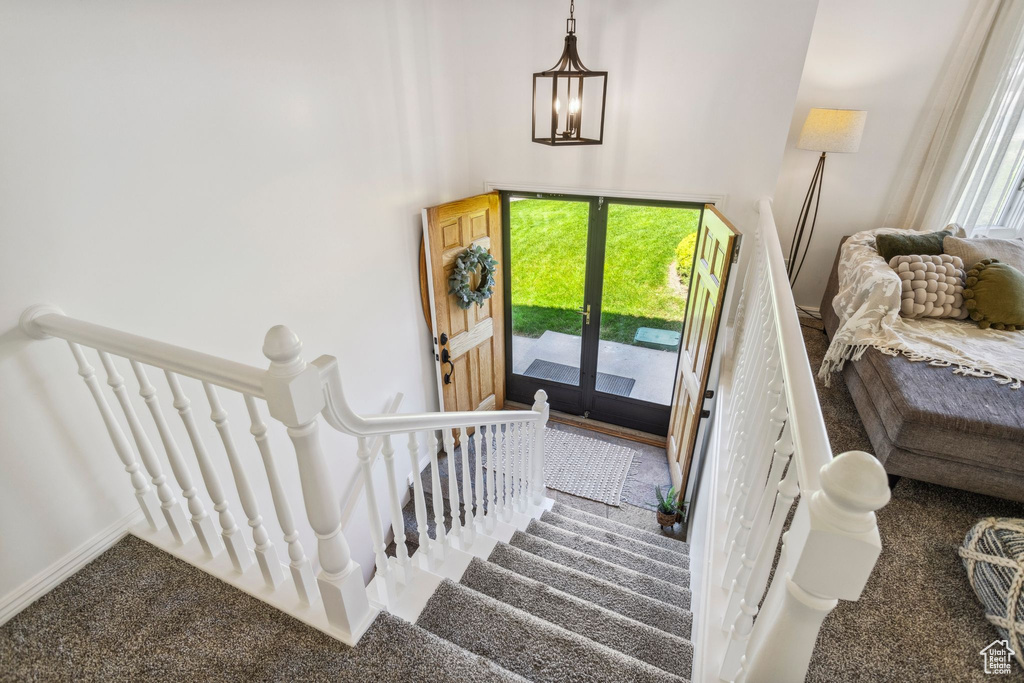 Stairway with carpet floors and plenty of natural light