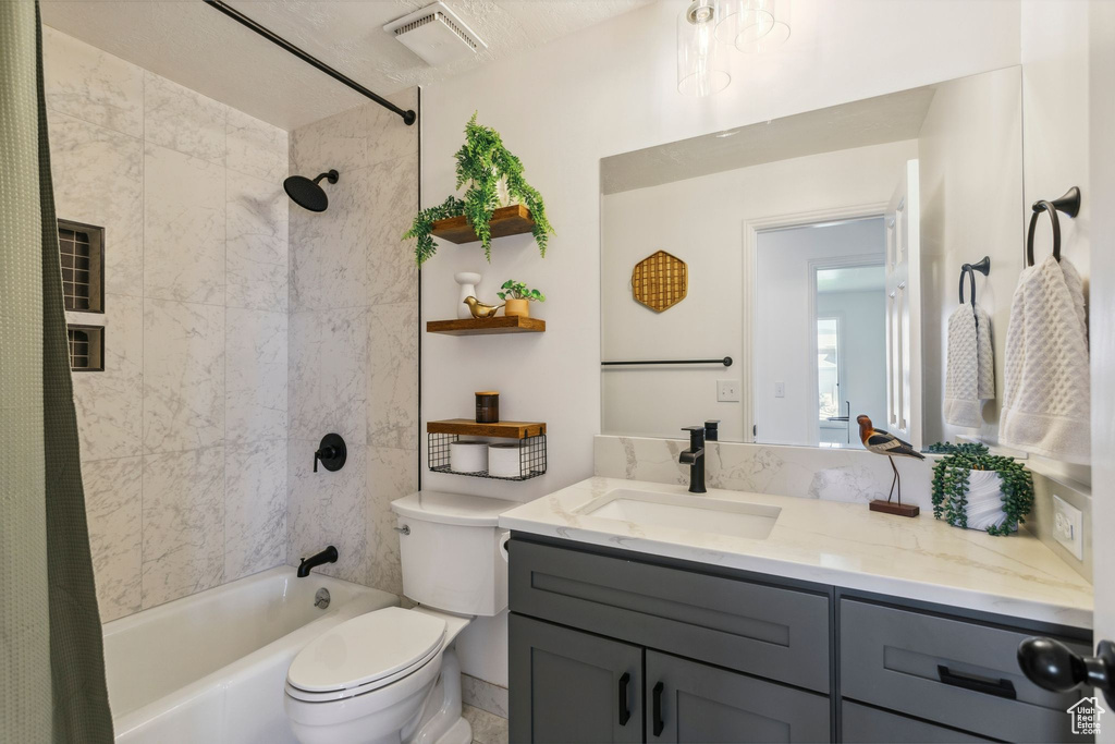 Full bath featuring vanity, toilet, and shower / tub combo with curtain