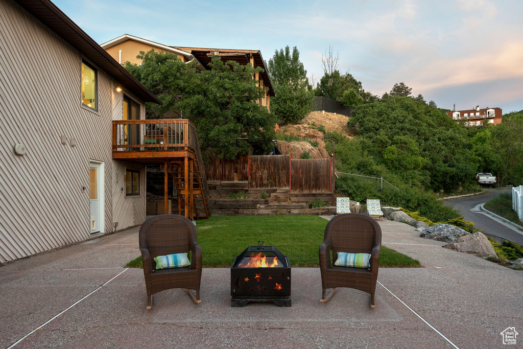 View of patio / terrace with an outdoor fire pit, a wooden deck, and stairs