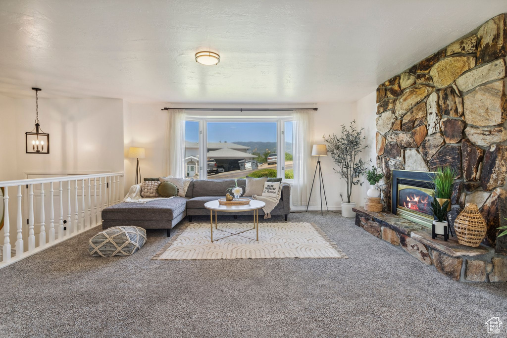 Living area featuring carpet flooring and a fireplace
