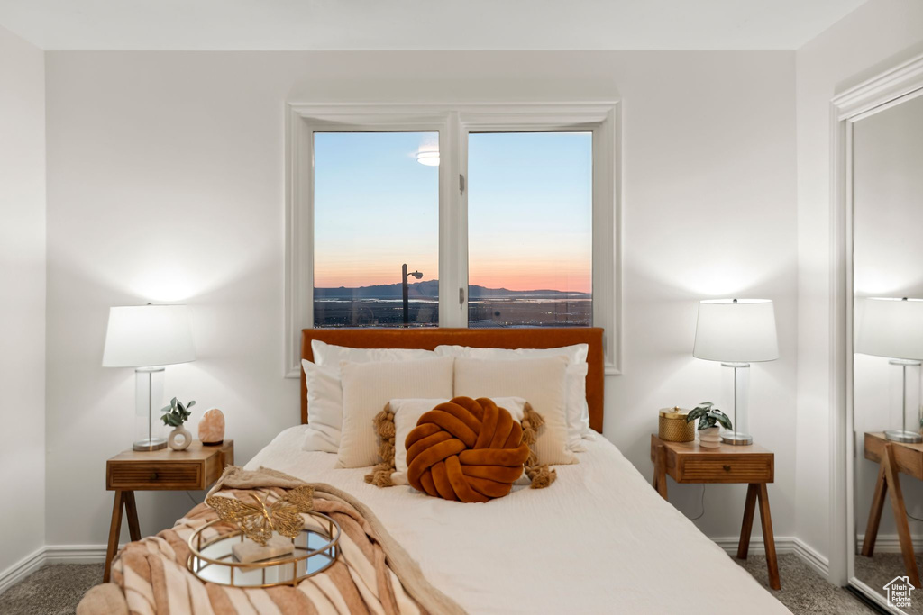 Bedroom featuring carpet flooring and baseboards