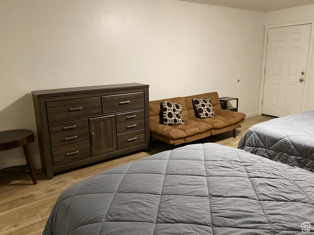 Bedroom featuring light wood finished floors and baseboards